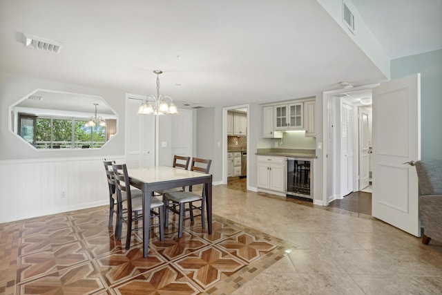 4201 N Ocean Blvd Unit 208, Boca Raton, FL 33431 - dining room featuring a notable chandelier, light tile patterned floors, visible vents, and wine cooler