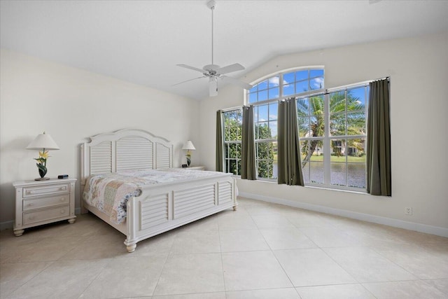 bedroom with light tile patterned floors, baseboards, ceiling fan, and vaulted ceiling