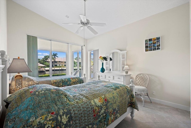 tiled bedroom with ceiling fan, vaulted ceiling, baseboards, a water view, and access to outside