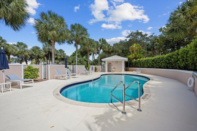 pool with fence and a patio area