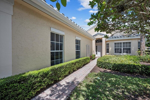 property entrance with stucco siding