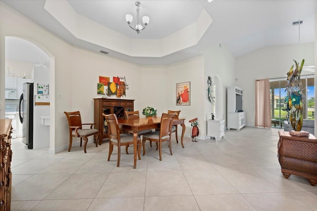 dining room featuring light tile patterned floors, arched walkways, high vaulted ceiling, and visible vents