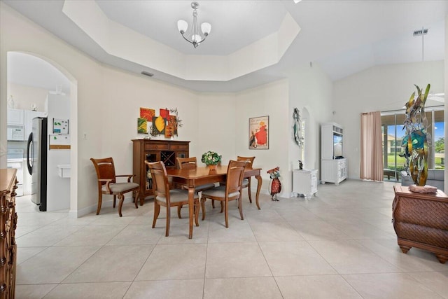 dining space with light tile patterned flooring, high vaulted ceiling, visible vents, and arched walkways