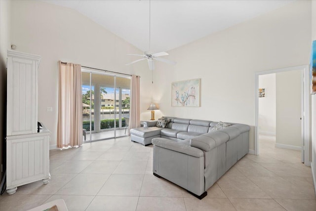 living area featuring baseboards, a ceiling fan, high vaulted ceiling, and light tile patterned floors