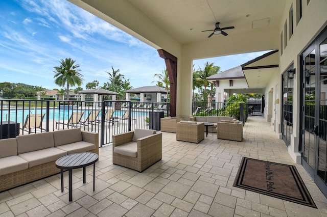 7339 NW 28th Way, Boca Raton, FL 33496 - view of patio with an outdoor hangout area, a ceiling fan, a community pool, and fence
