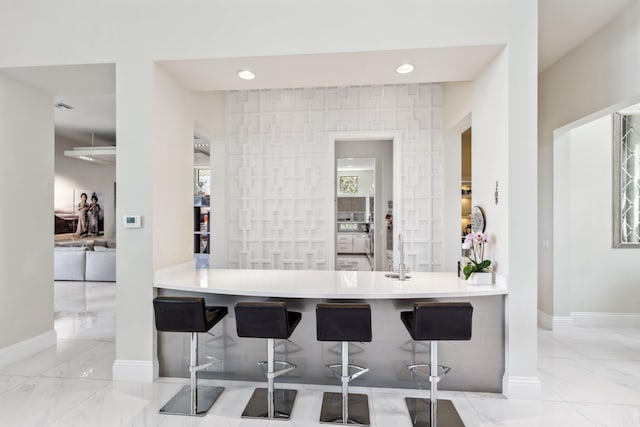 7339 NW 28th Way, Boca Raton, FL 33496 - bar featuring marble finish floor, a sink, and baseboards