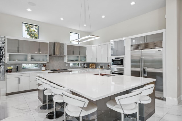 7339 NW 28th Way, Boca Raton, FL 33496 - kitchen with marble finish floor, a kitchen breakfast bar, stainless steel appliances, and decorative backsplash