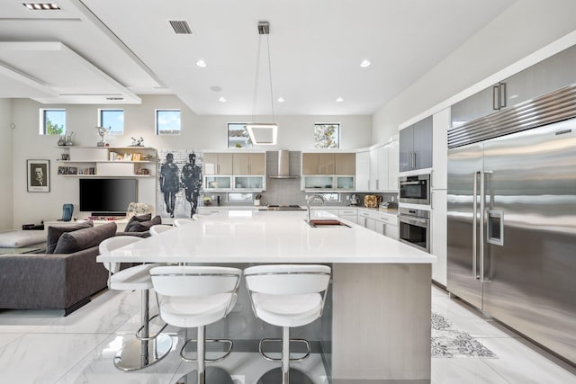 7339 NW 28th Way, Boca Raton, FL 33496 - kitchen featuring a breakfast bar area, stainless steel appliances, light countertops, and a sink