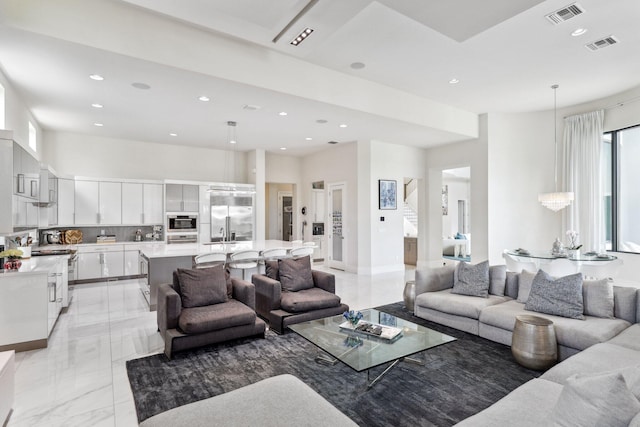 7339 NW 28th Way, Boca Raton, FL 33496 - living area with a high ceiling, recessed lighting, marble finish floor, and visible vents