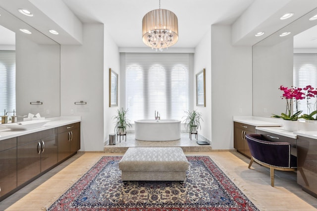 7339 NW 28th Way, Boca Raton, FL 33496 - bathroom with a soaking tub, a chandelier, baseboards, recessed lighting, and vanity