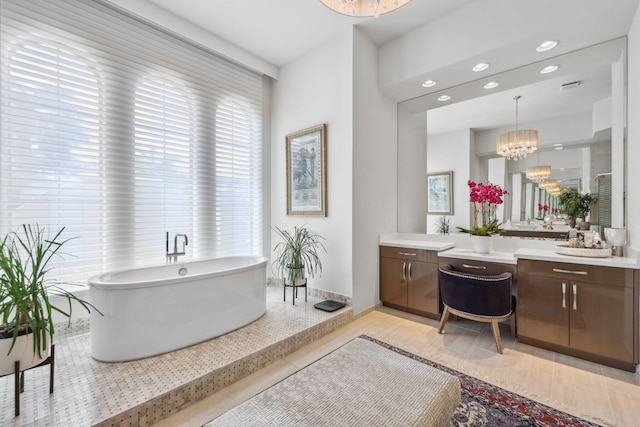 7339 NW 28th Way, Boca Raton, FL 33496 - full bath with recessed lighting, vanity, a chandelier, baseboards, and a soaking tub