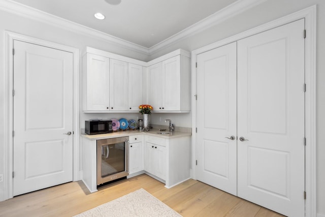 7339 NW 28th Way, Boca Raton, FL 33496 - bar featuring crown molding, wine cooler, a sink, and light wood-type flooring