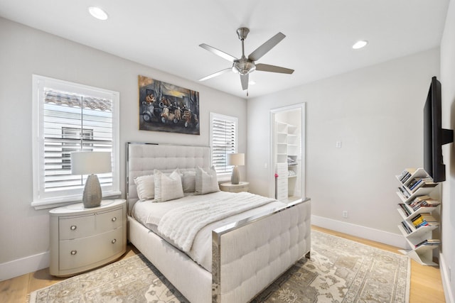 7339 NW 28th Way, Boca Raton, FL 33496 - bedroom with a walk in closet, recessed lighting, light wood finished floors, and baseboards