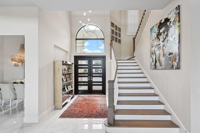 7339 NW 28th Way, Boca Raton, FL 33496 - foyer entrance featuring stairway, baseboards, a towering ceiling, french doors, and marble finish floor