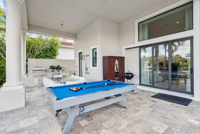 7339 NW 28th Way, Boca Raton, FL 33496 - rec room featuring stone finish floor, pool table, a wealth of natural light, and decorative columns