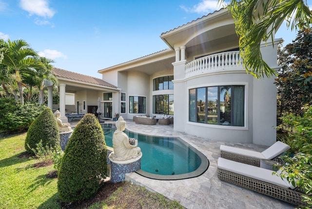 7339 NW 28th Way, Boca Raton, FL 33496 - rear view of property featuring a tile roof, an outdoor pool, stucco siding, and a patio area