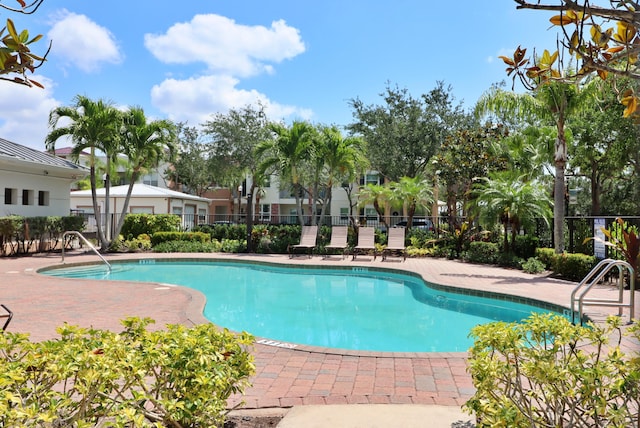 10520 SW Stephanie Way Unit 2204, Port Saint Lucie, FL 34987 - community pool featuring a patio and fence