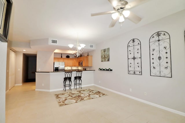 10520 SW Stephanie Way Unit 2204, Port Saint Lucie, FL 34987 - kitchen featuring appliances with stainless steel finishes, baseboards, ceiling fan with notable chandelier, and visible vents