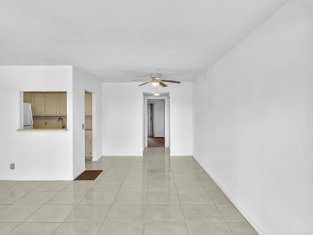 271 Tilford M Unit 271, Deerfield Beach, FL 33442 - empty room featuring a ceiling fan, a textured ceiling, light tile patterned flooring, and a sink