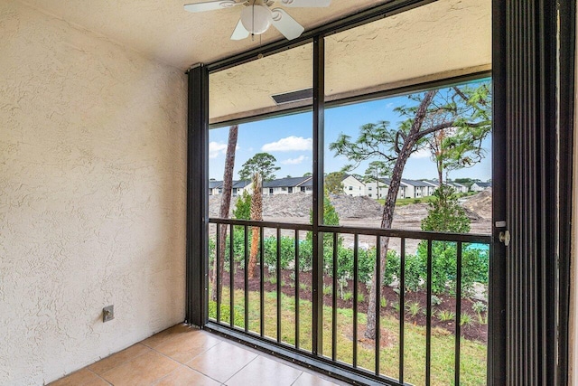 exterior details with stucco siding, a ceiling fan, and a residential view