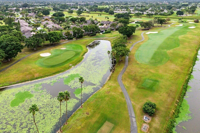 drone / aerial view with golf course view, a water view, and a residential view