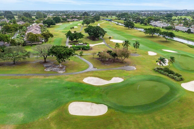 birds eye view of property featuring a water view and view of golf course