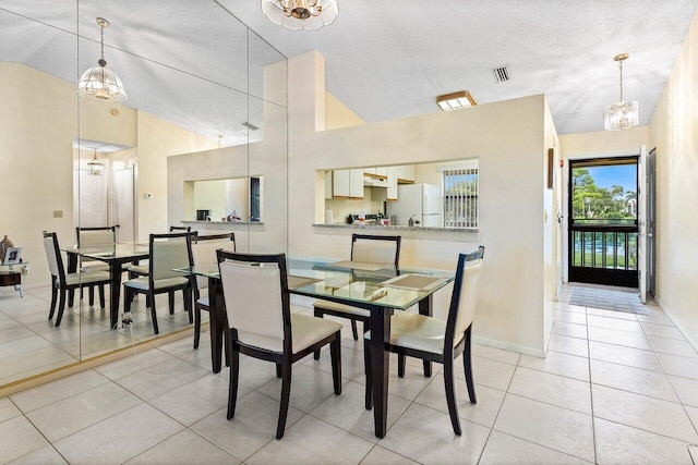 dining space featuring light tile patterned floors, visible vents, a notable chandelier, and baseboards