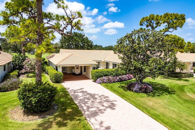 4511 Meadowlark Ln, Boynton Beach, FL 33436 - ranch-style house featuring a front lawn, driveway, stucco siding, and a tile roof