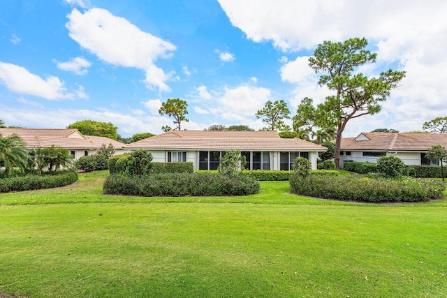 4511 Meadowlark Ln, Boynton Beach, FL 33436 - view of front of house featuring a front lawn and a tile roof