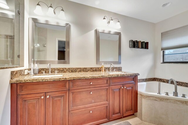 bathroom featuring a garden tub, a sink, a shower with shower door, and double vanity
