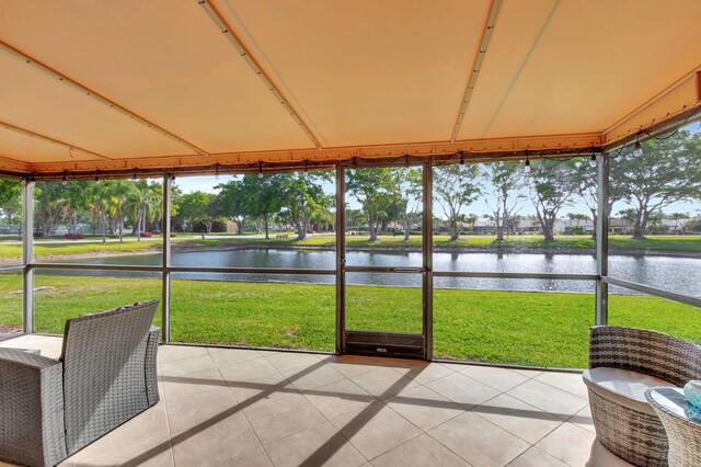 unfurnished sunroom with a water view