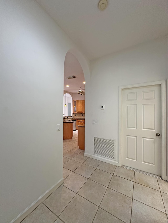 573 SW Saint Kitts St, Port Saint Lucie, FL 34953 - hallway featuring arched walkways and light tile patterned flooring