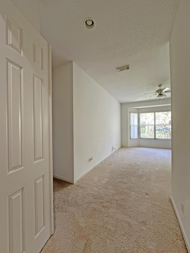 573 SW Saint Kitts St, Port Saint Lucie, FL 34953 - unfurnished room with carpet floors, a ceiling fan, and a textured ceiling