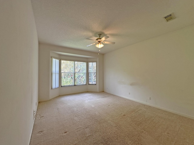 573 SW Saint Kitts St, Port Saint Lucie, FL 34953 - carpeted spare room with a ceiling fan and a textured ceiling
