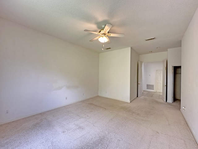 573 SW Saint Kitts St, Port Saint Lucie, FL 34953 - unfurnished room featuring light carpet, a ceiling fan, and a textured ceiling