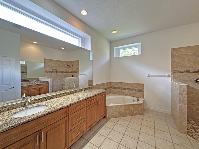 573 SW Saint Kitts St, Port Saint Lucie, FL 34953 - full bath with a walk in shower, a garden tub, vanity, tile patterned flooring, and a textured ceiling