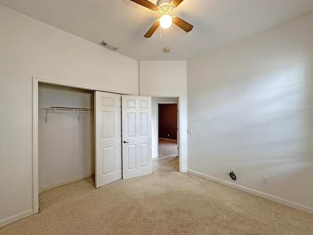573 SW Saint Kitts St, Port Saint Lucie, FL 34953 - unfurnished bedroom featuring light colored carpet, a closet, and a ceiling fan
