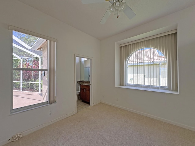 573 SW Saint Kitts St, Port Saint Lucie, FL 34953 - spare room with healthy amount of natural light, light colored carpet, ceiling fan, and a water view