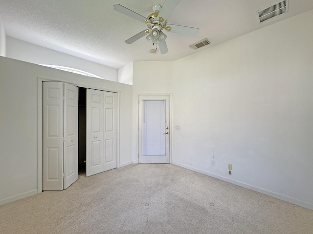 573 SW Saint Kitts St, Port Saint Lucie, FL 34953 - unfurnished bedroom with carpet floors, a ceiling fan, a closet, and a textured ceiling