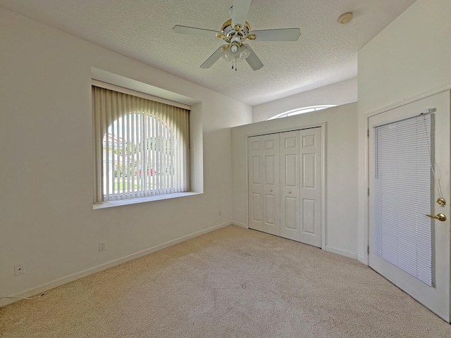 573 SW Saint Kitts St, Port Saint Lucie, FL 34953 - unfurnished bedroom with carpet floors, a textured ceiling, a ceiling fan, and a closet