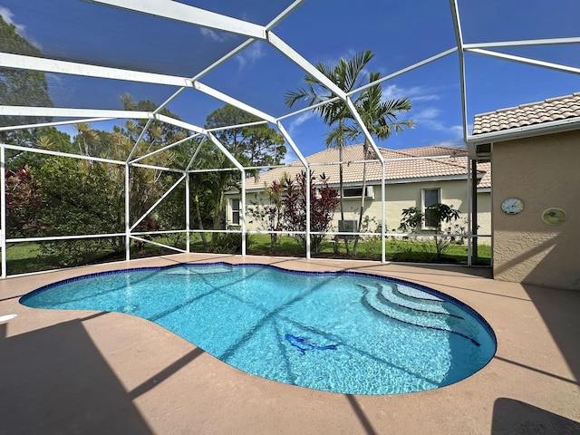 573 SW Saint Kitts St, Port Saint Lucie, FL 34953 - outdoor pool featuring a patio and glass enclosure