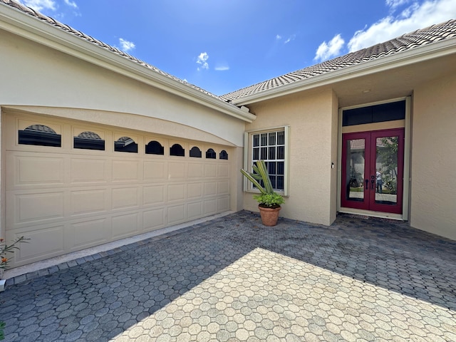 573 SW Saint Kitts St, Port Saint Lucie, FL 34953 - garage featuring french doors and decorative driveway