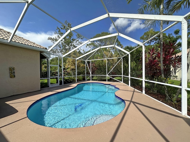 573 SW Saint Kitts St, Port Saint Lucie, FL 34953 - outdoor pool featuring a patio and glass enclosure