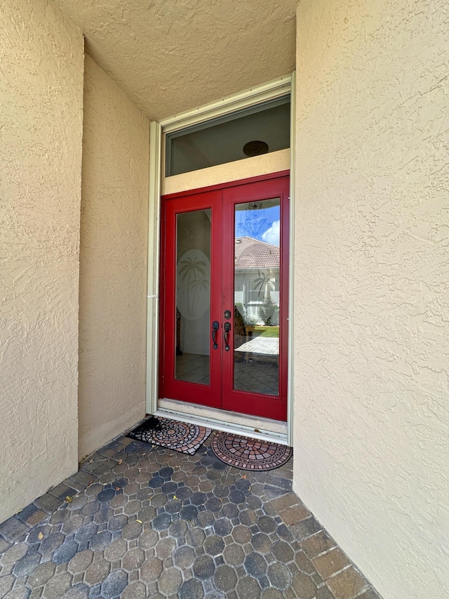 573 SW Saint Kitts St, Port Saint Lucie, FL 34953 - property entrance with french doors and stucco siding
