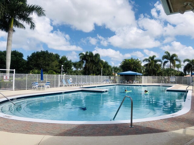 573 SW Saint Kitts St, Port Saint Lucie, FL 34953 - community pool featuring a patio area
