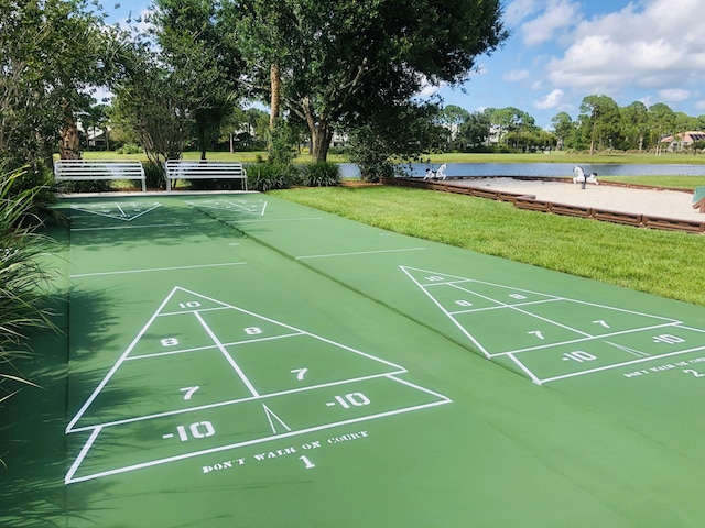573 SW Saint Kitts St, Port Saint Lucie, FL 34953 - view of community with a water view, a lawn, and shuffleboard
