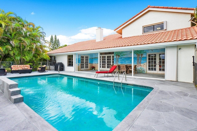view of pool featuring a fenced in pool, a patio area, outdoor lounge area, fence, and french doors