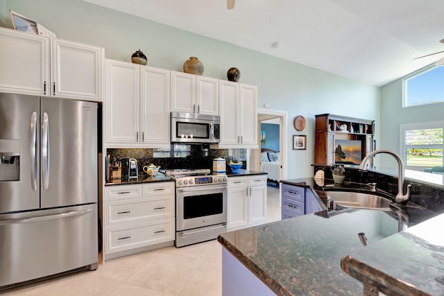 kitchen featuring a sink, decorative backsplash, appliances with stainless steel finishes, and white cabinets