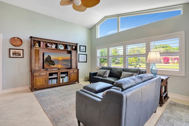 living room with baseboards, ceiling fan, light tile patterned floors, and high vaulted ceiling