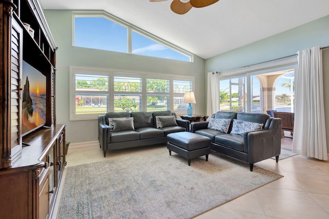 living area featuring ceiling fan, light tile patterned floors, and high vaulted ceiling